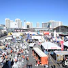 Las Vegas convention center with trade show booths, equipment displays, and city skyline