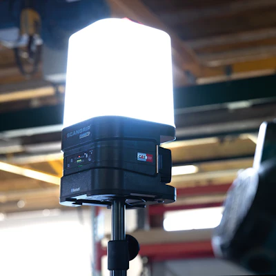 Bright white LED work light mounted on adjustable stand in industrial setting