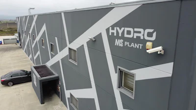 Gray industrial building with Hydro MS Plant logo and security camera