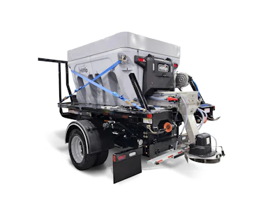 Industrial snow spreader truck with gray hopper and mechanical spreading equipment