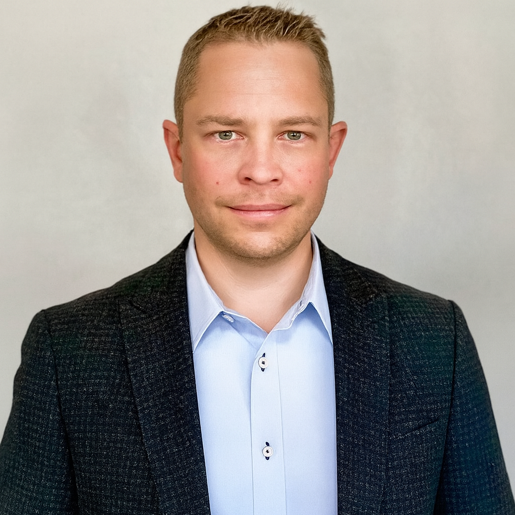 Professional man in dark textured blazer and light blue shirt Headshot