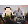 Conexpo Con/Agg conference speaker presenting on stage with event logo