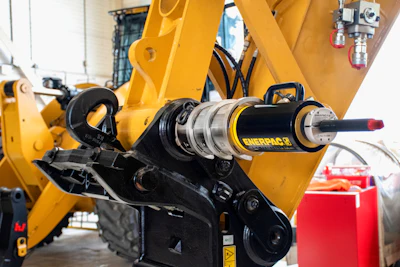 Yellow industrial hydraulic machinery with Enerpac cylinder and mechanical components