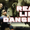 Workers in safety gear near industrial equipment with 'Real Life Danger' text