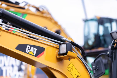 Yellow Caterpillar construction excavator with hydraulic arm and CAT logo