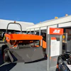 Orange JLG industrial machine on display at an outdoor exhibit