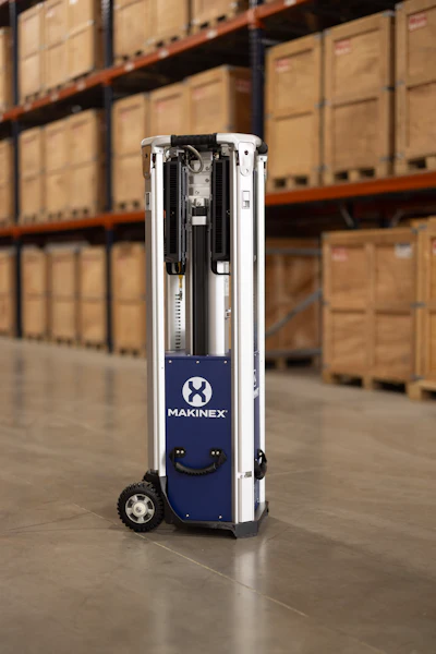 Makinex mobile robotic device in warehouse with storage shelves in background