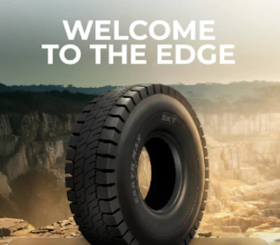 Heavy-duty truck tire displayed against desert landscape with 'Welcome to the Edge' text overlay