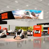 Bobcat construction equipment display with white and orange booth featuring heavy machinery