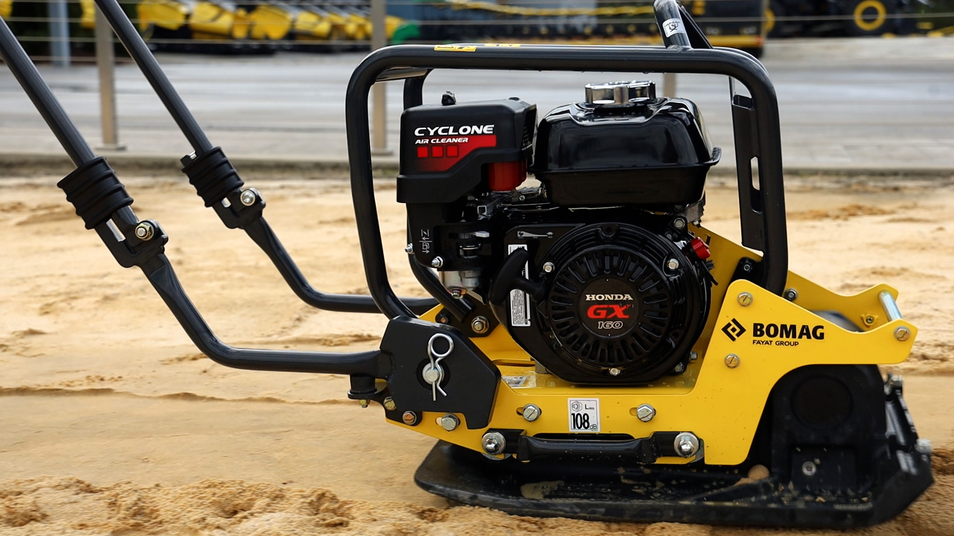 Yellow Bomag plate compactor with Cyclone engine on sandy construction site