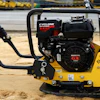Yellow Bomag plate compactor with Cyclone engine on sandy construction site