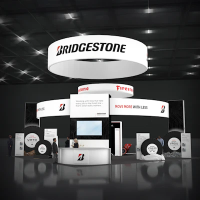 Bridgestone trade show booth with illuminated signage, featuring 'Move More with Less' tagline and multiple product displays