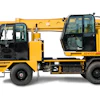 Yellow Gradall XE4100 telescopic boom truck with extended boom arm and cab, viewed from the side