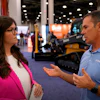 Professional discussing construction equipment at industry trade show