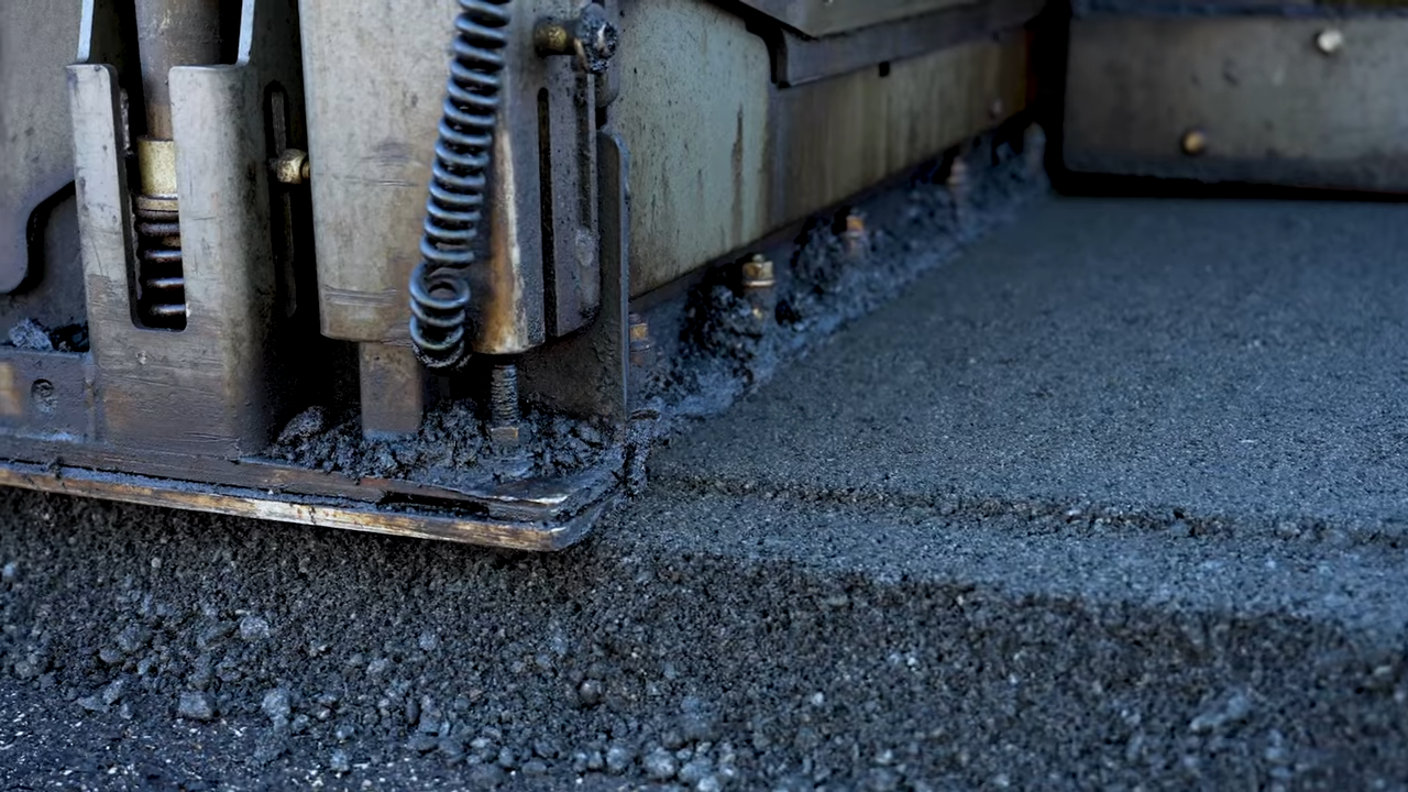 Industrial machinery edge with metal components and textured surface