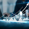 Business professional analyzing financial growth charts with upward trending arrows and bar graphs on digital display