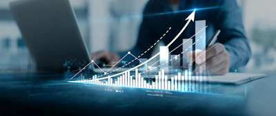 Business professional analyzing financial growth charts with upward trending arrows and bar graphs on digital display