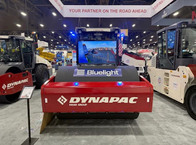 Red Dynapac compactor with Bluelight branding at construction equipment trade show booth