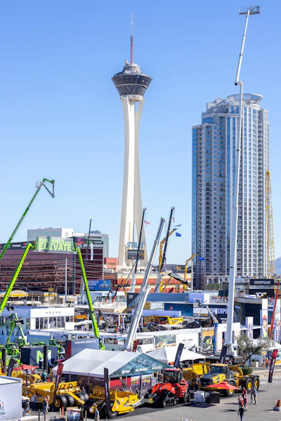 Construction equipment trade show with Stratosphere tower and Las Vegas high-rise buildings in background