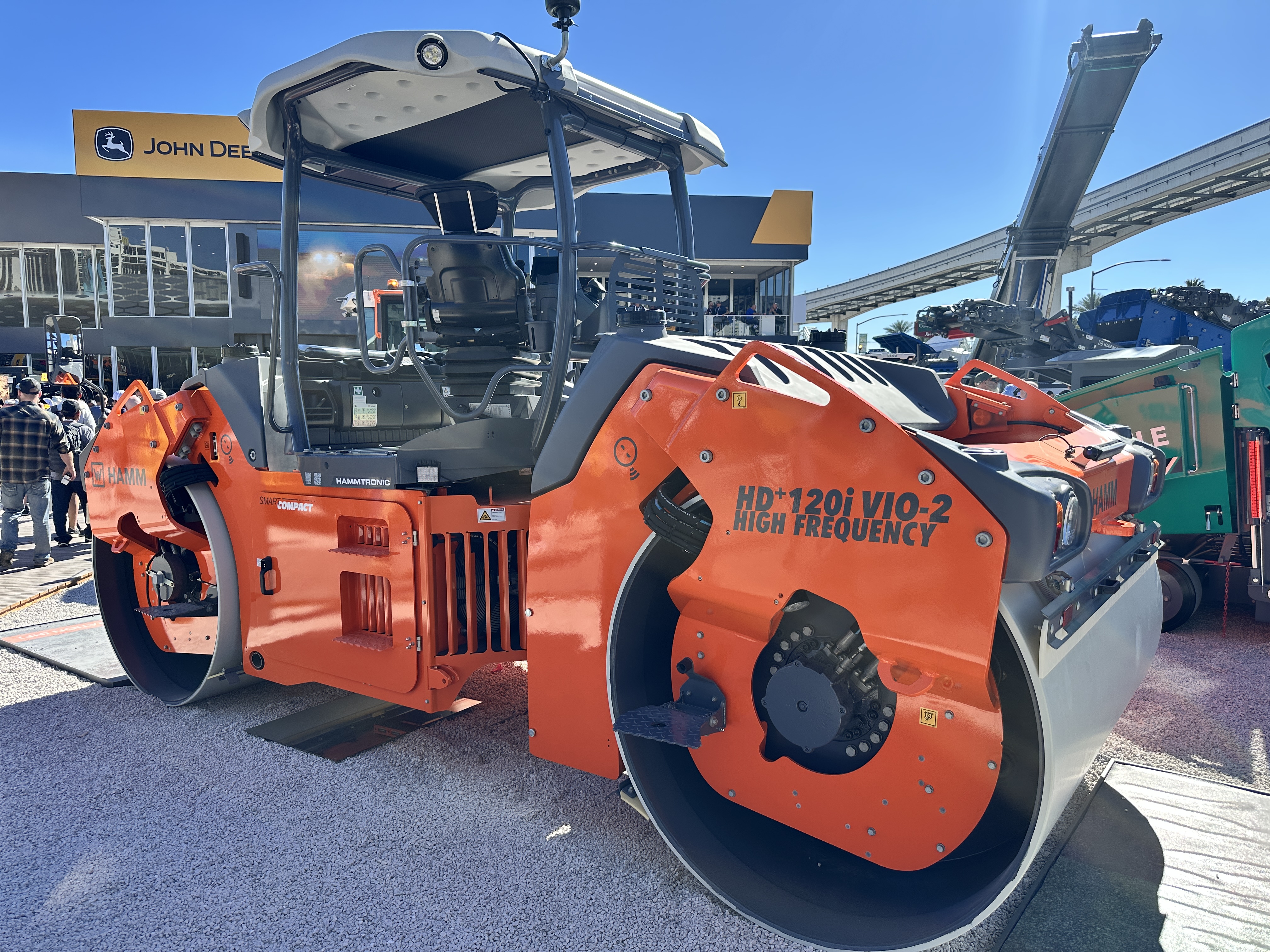 Orange Hamm HD120i VIO-2 vibratory roller compactor on display at outdoor equipment dealership
