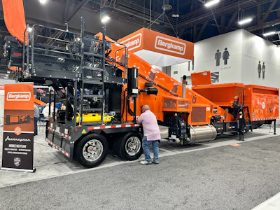 Bergkamp industrial equipment display at trade show with orange and black machinery and mobile air plant units