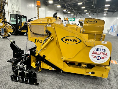 Yellow Weiler snow removal equipment with black hydraulic attachment displayed in industrial warehouse setting