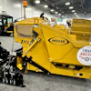 Yellow Weiler industrial wood chipper with black mechanical components displayed at trade show