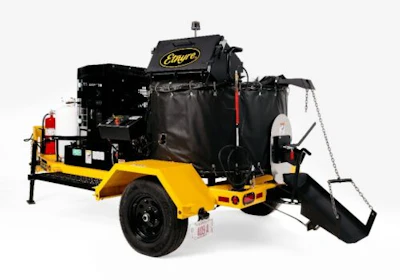Yellow and black Champ asphalt paving machine with tow trailer on white background
