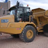 Yellow Caterpillar 730 articulated dump truck on display at urban construction equipment exhibition