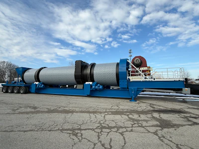 Large blue industrial dryer unit mounted on multi-axle trailer in outdoor lot