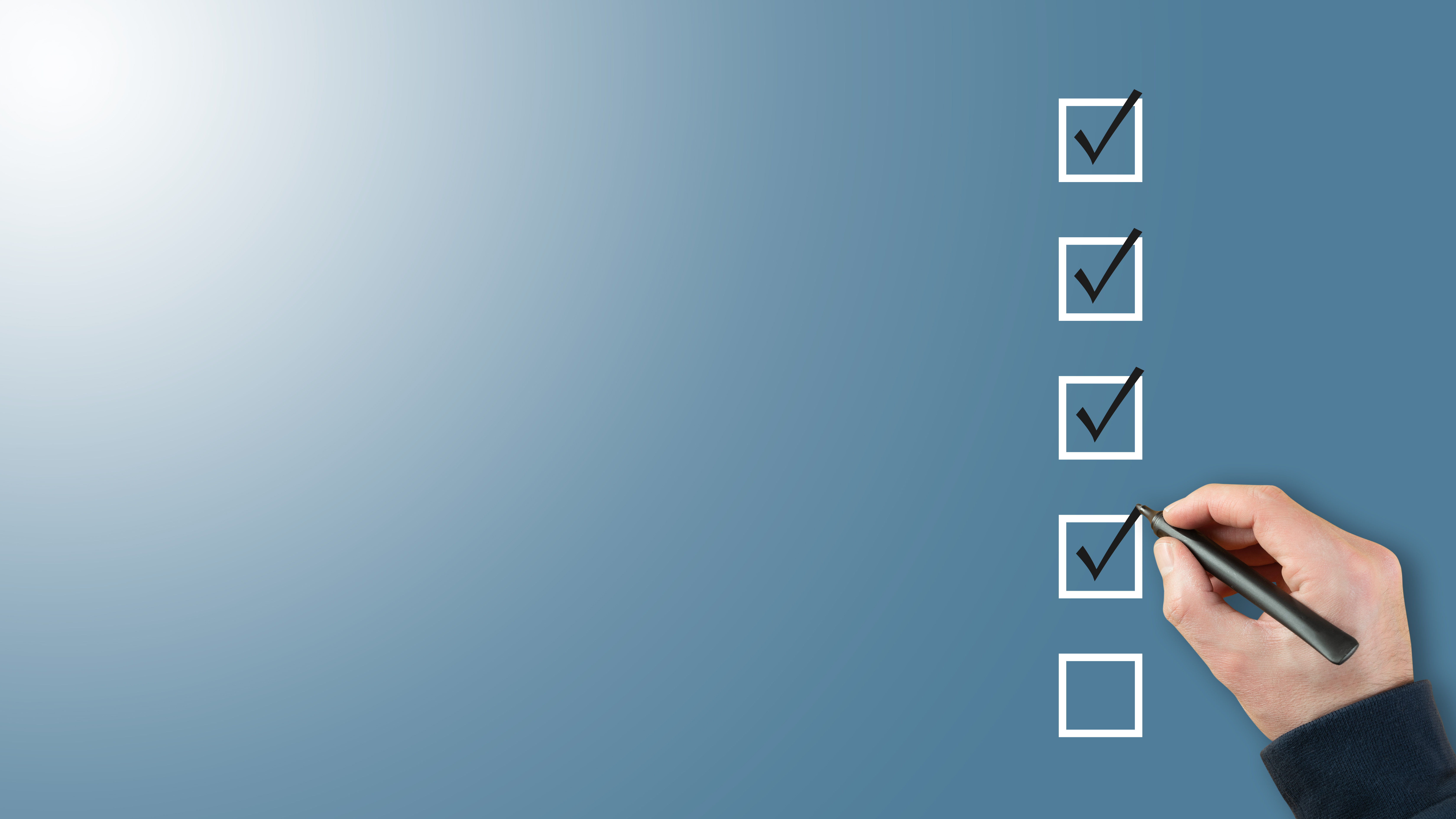 Hand checking off completed tasks on a blue checklist with pen