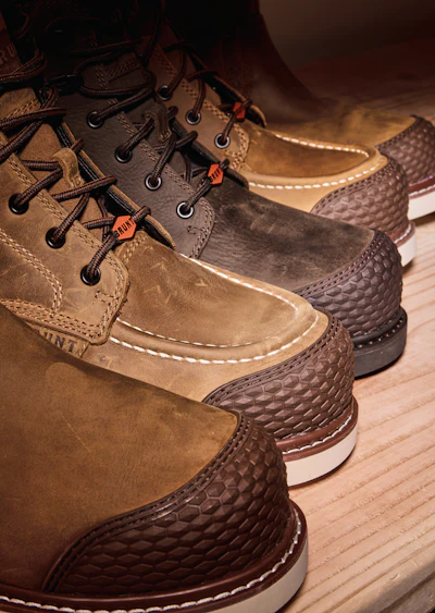 Collection of tan and brown leather duck boots with textured rubber soles displayed on wooden flooring