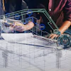 Engineers reviewing digital construction plans with AR overlay on tablet near blueprints and safety helmet