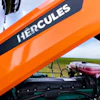 Hercules tractor hood with white text branding on orange metal surface