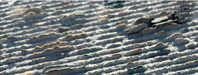 Rippled water surface with wave patterns and shadows creating natural texture