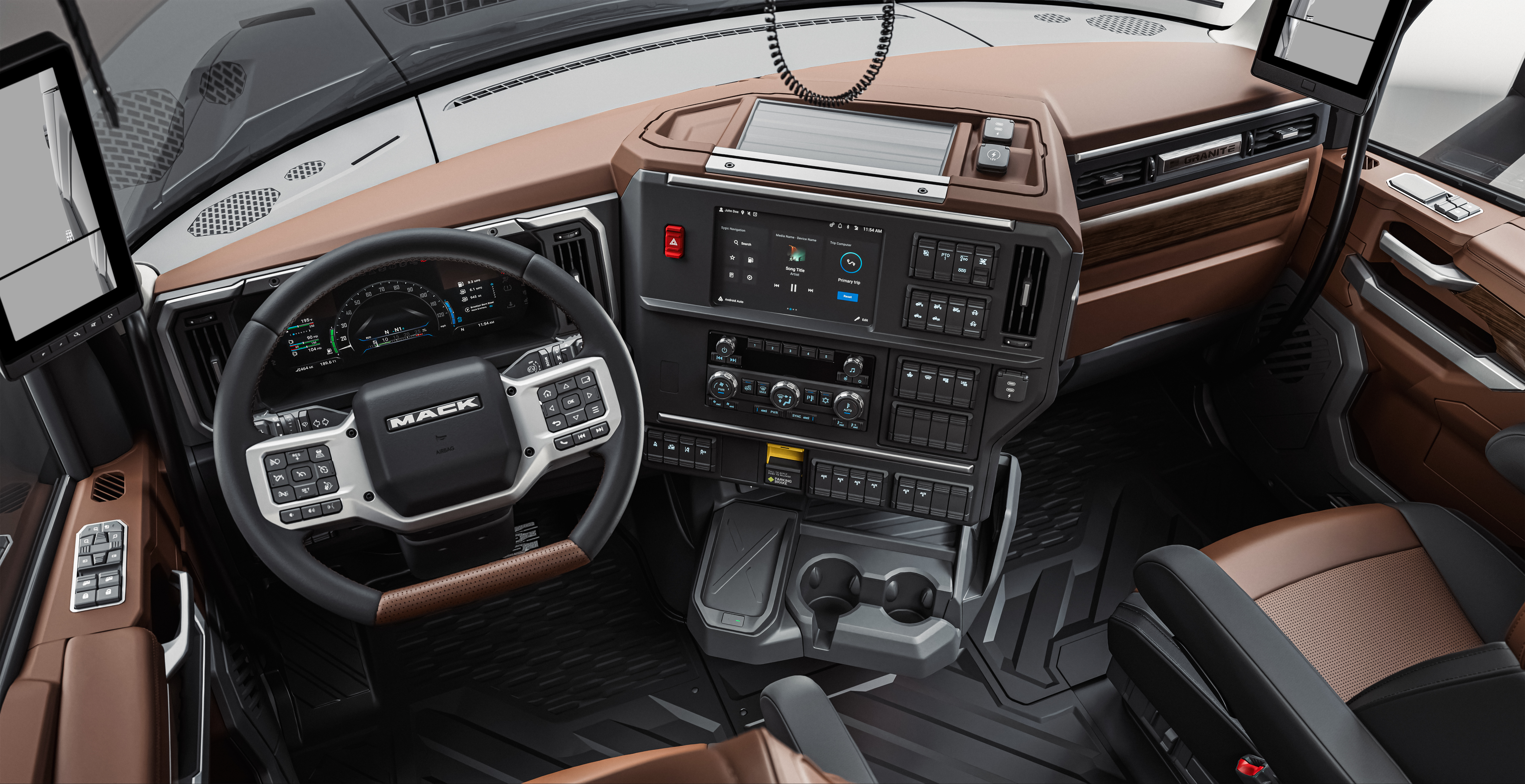 Mack Trucks commercial vehicle interior cabin with brown leather seats, black steering wheel, and digital dashboard display