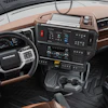Mack Trucks commercial vehicle interior cabin with brown leather seats, black steering wheel, and digital dashboard display
