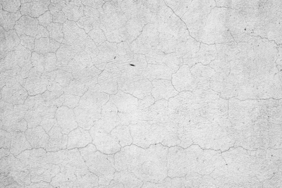 Cracked concrete surface with fine fracture lines and weathered texture