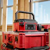 Red and black portable power station stacked on storage cases in construction framing