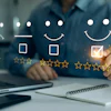 Person selecting five-star rating on customer satisfaction feedback survey displayed on laptop screen