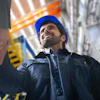 Construction worker in blue hard hat looking upward on industrial job site