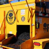 Yellow and orange pothole repair machine with skull logo and 'Pothole Punisher' branding