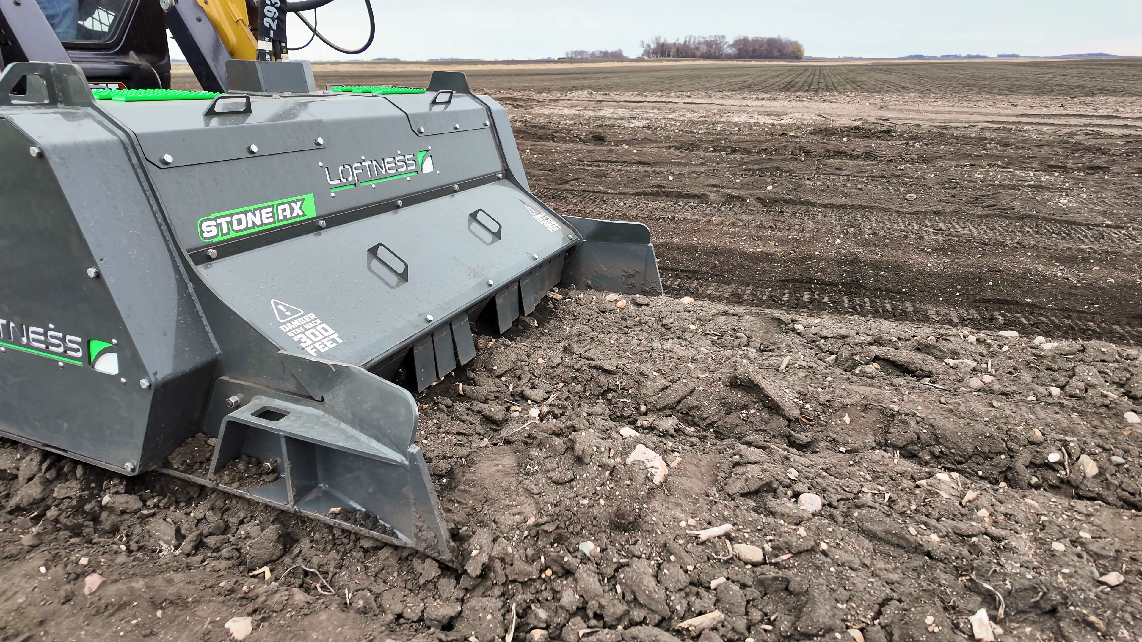 Stone RX agricultural equipment with green accents operating in a plowed field