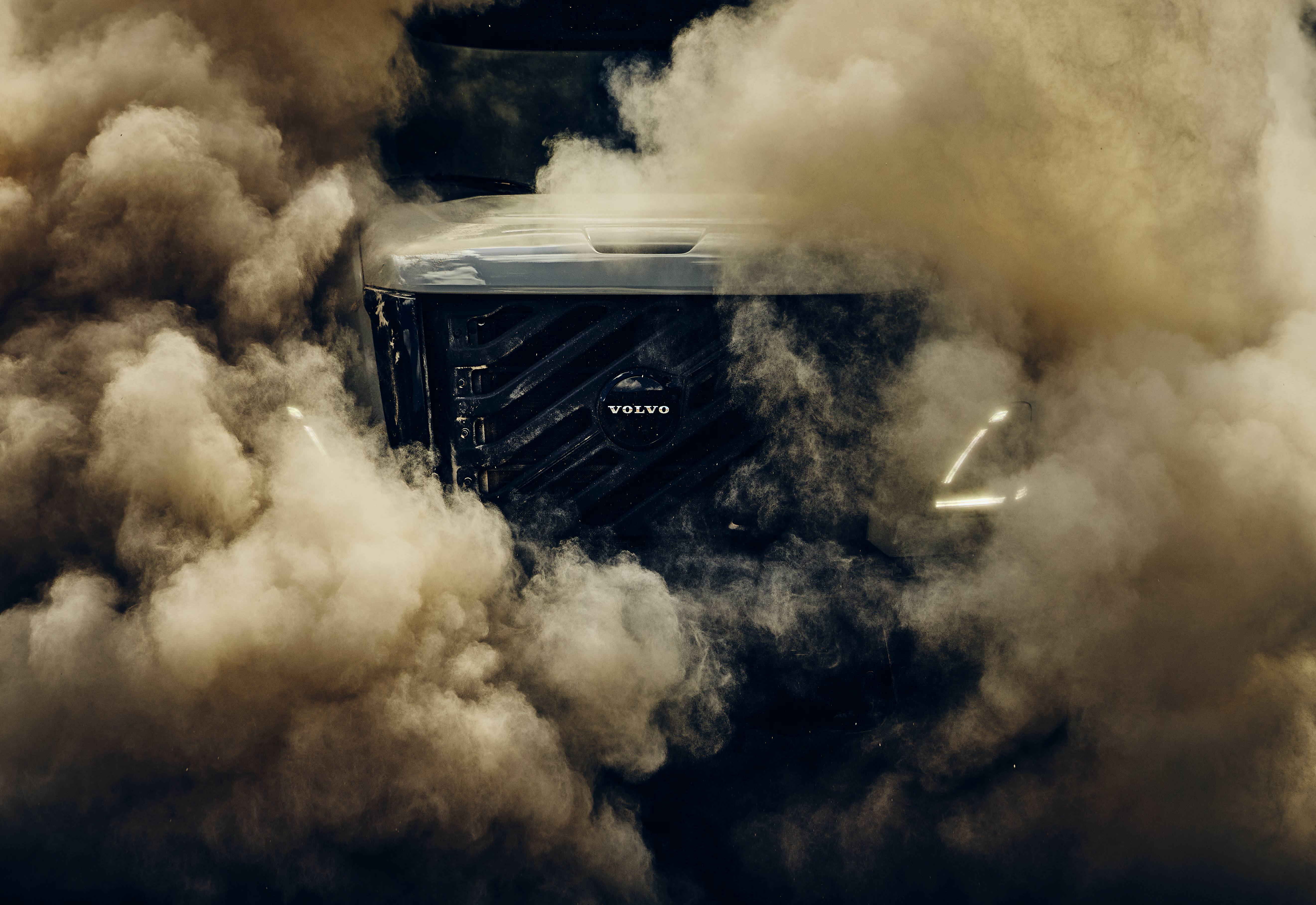 Volvo truck engulfed in dust clouds during high-speed off-road driving