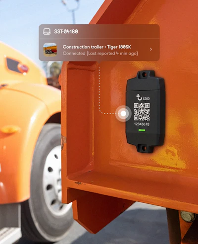 S300 GPS tracker device mounted on orange construction trailer with QR code and serial number